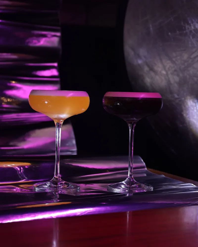 Sample photo: two cocktails in purple light