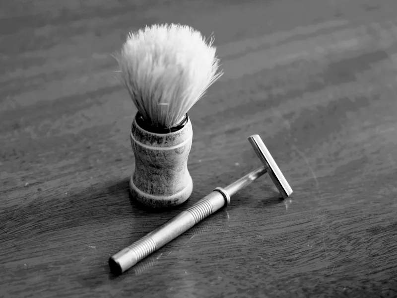 Sample photo: a shaving brush and razor on a wooden table