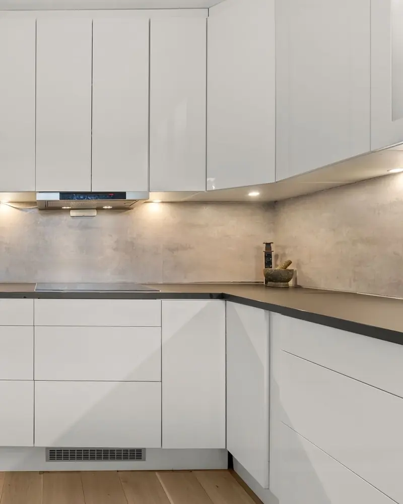 Sample photo: a bright finished kitchen with white cabinets