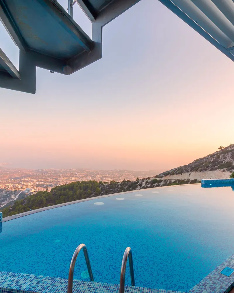 Sample photo: a villa infinity pool on a hillside at sunset