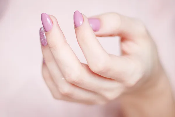 Hand with soft pink nails