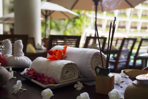 Rolled towels and flowers on a spa table